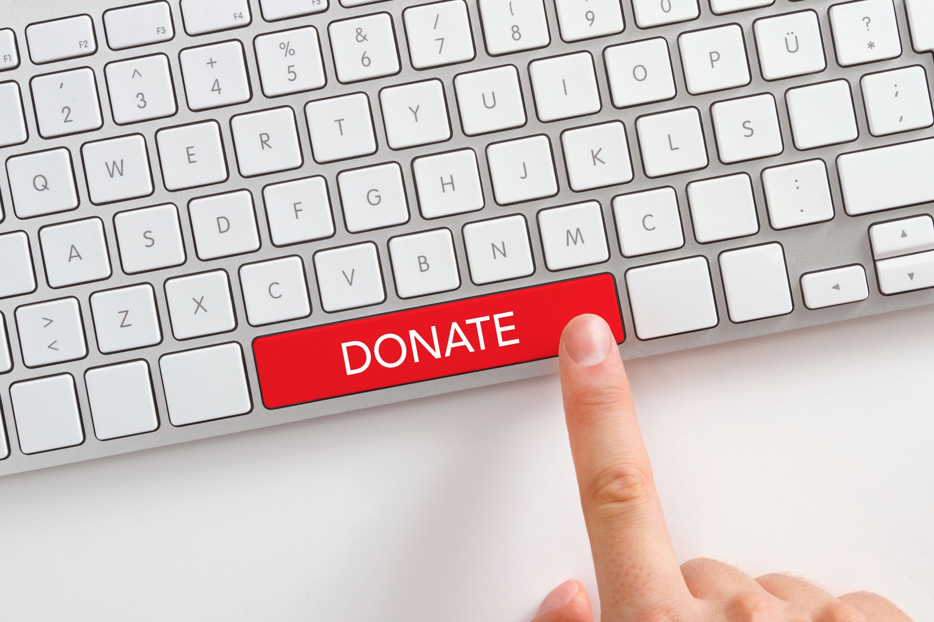 Human Finger is Pushing Donate Button on Keyboard